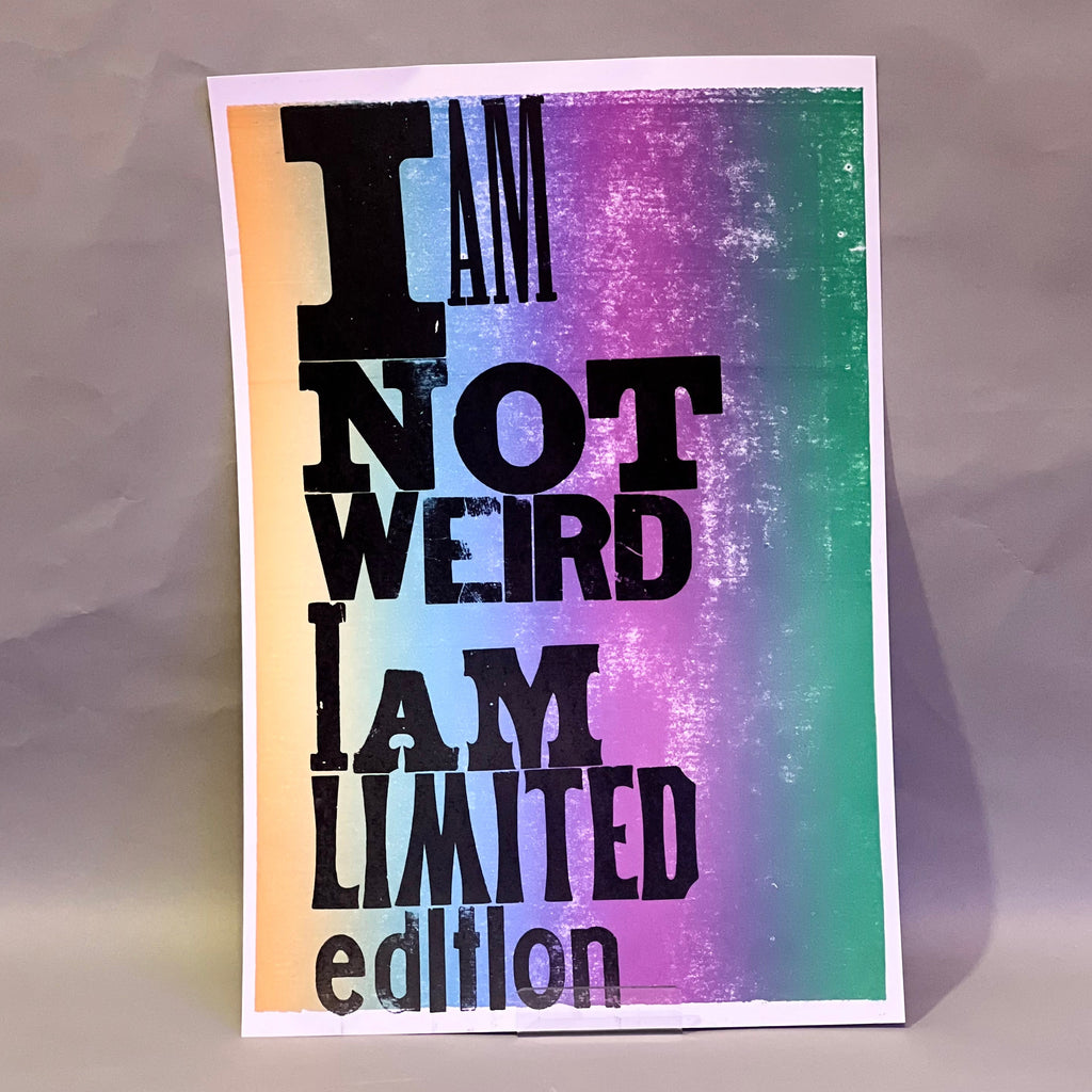 Colorful poster with text 'I AM NOT WEIRD I AM LIMITED edition' on a textured surface, printed on letterpress.