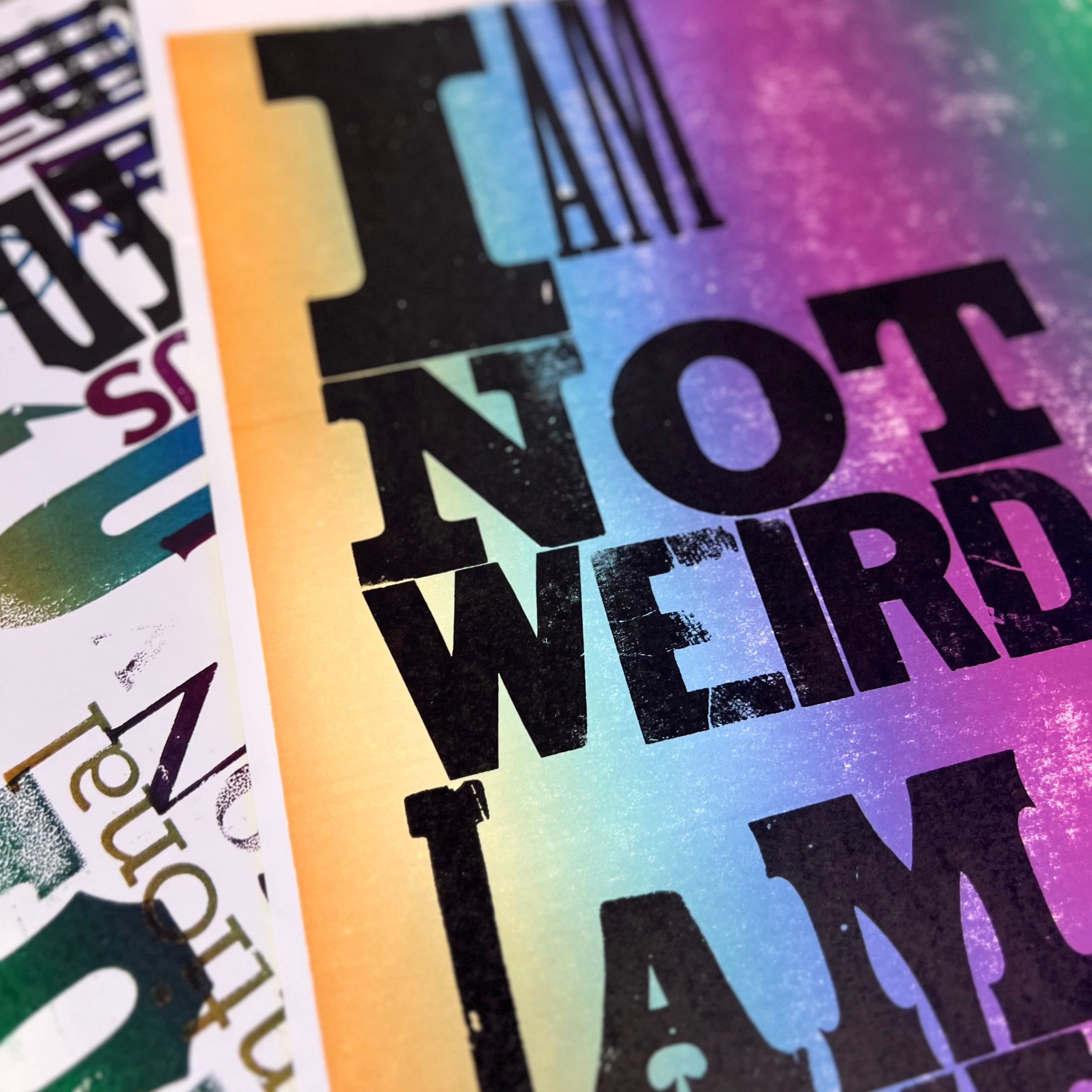 Colorful poster with text 'I AM NOT WEIRD I AM LIMITED edition' on a textured surface, printed on letterpress.