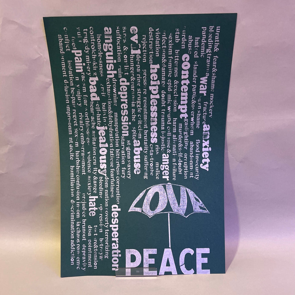 Rain of unpleasant words falling from above, while the word “Love” forms an umbrella that offers protection. Beneath it, the word “Peace”