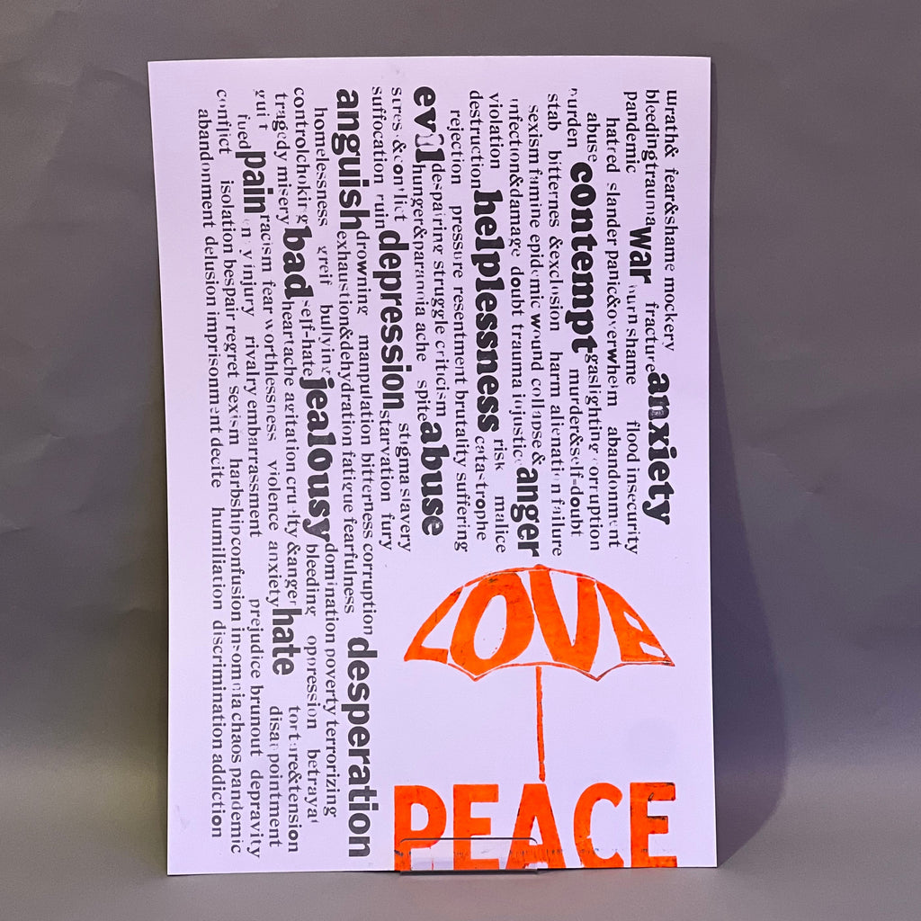 Rain of unpleasant words falling from above, while the word “Love” forms an umbrella that offers protection. Beneath it, the word “Peace”